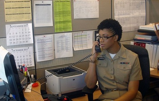 Lt. Nisha Antoine, in her U.S. Public Health Service Commissioned Corps uniform, works at her desk in one of the Food Safety and Inspection Service’s headquarters offices.