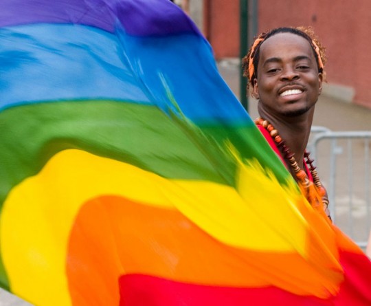 An activist waves a rainbow flag, an international symbol for the rights of gay, lesbian, bisexual and transgender people. Photo: Flickr/See-ming Lee