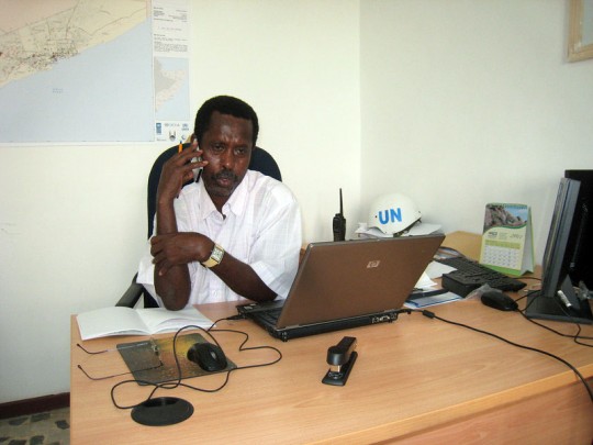 Ahmed Farah Roble speaks with a Somali NGO representative while in the Mogadishu sub-office.