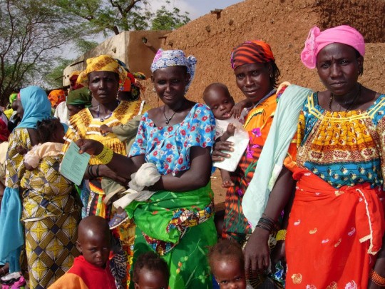 Mothers with hungry children lining up at distribution site in Taoa, Niger, for food handouts
