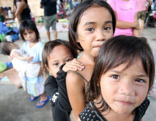 A group of children displaced by floods, following the passage of tropical storm Washi, living in an evacuation centre in Iligan City, Philippines