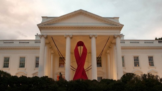 A red ribbon is hung from the North Portico of the White House to mark World AIDS Day, White House Photo, Chuck Kennedy