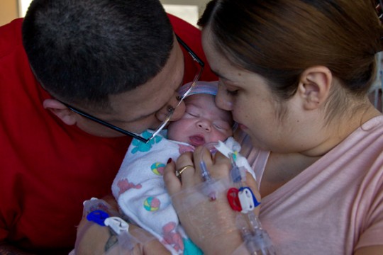 Luis Gutierrez, 30, and fiance Eveth Martinez, 27, pose with their newborn son Joey, who was the first baby born at UCSF in 2012.