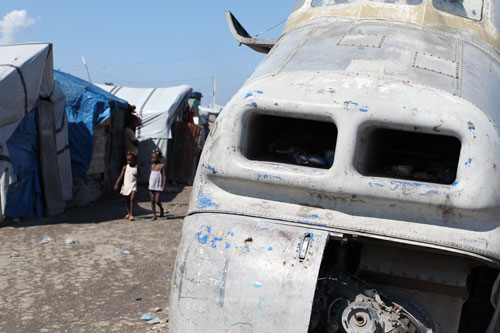 The camp was built on the grounds of an abandoned airport and its residents live among the remains of decommissioned planes in unsanitary conditions.