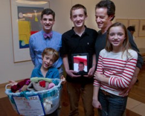 Andrea Fisher's children and husband presented knitted caps at the Stanford Cancer Center. Left to right: Miles Fisher, 8; Alexander Colevas, MD; Ryan Fisher, 15; Steve Fisher; and Katelyn Fisher, 12.