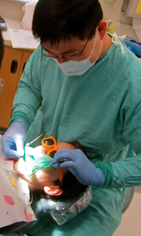 Brent Lin, DMD, examines patient Moses Peralta at the UCSF School of Dentistry Dental Clinic at Parnassus.