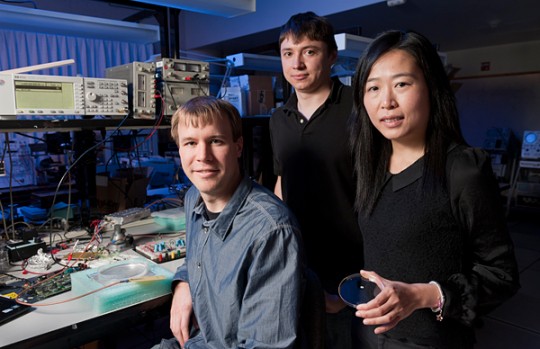 Professor Ada Poon, right, with graduate students Daniel Pivonka, left, and Anatoly Yakovlev, center. In the dish she is holding is the device that they created.