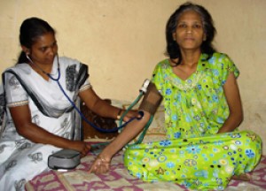 A home care nurse measures the blood pressure of a terminal cervical cancer patient in Uttam Nagar, New Delhi, India. © 2007 Divya Pal Singh, Courtesy of Photoshare