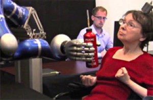 A participant uses her thoughts to control a robotic arm and successfully manipulate a bottle. Photo by the BrainGate Collaboration.
